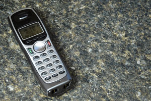 modern cordless phone atop a granite countertop